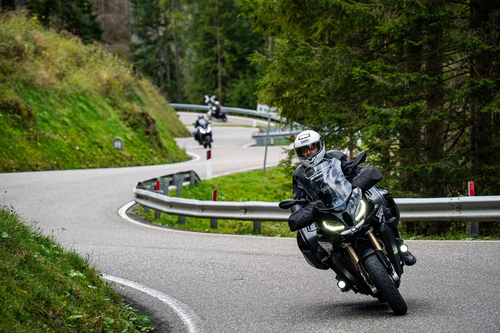 person riding a motorcycle down a winding road