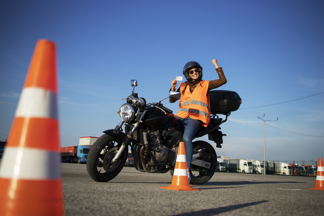 women cheering on a motorcycle after getting her license